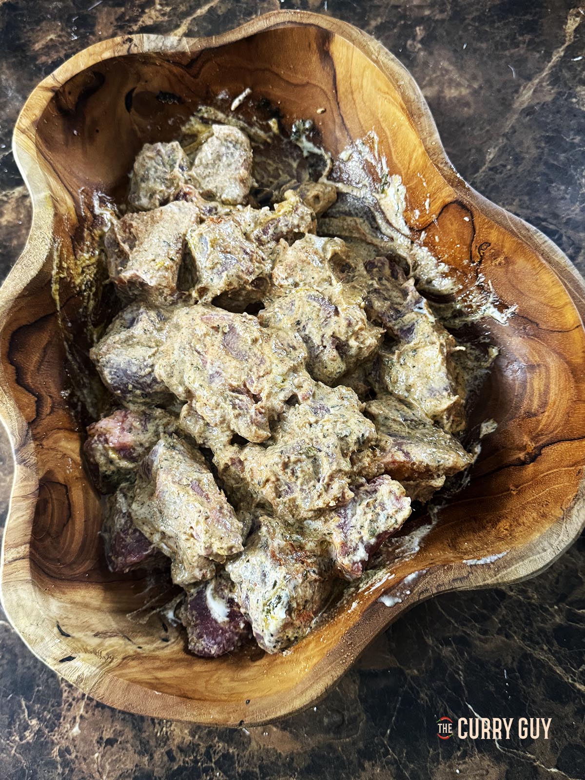 The marinade rubbed into the lamb.