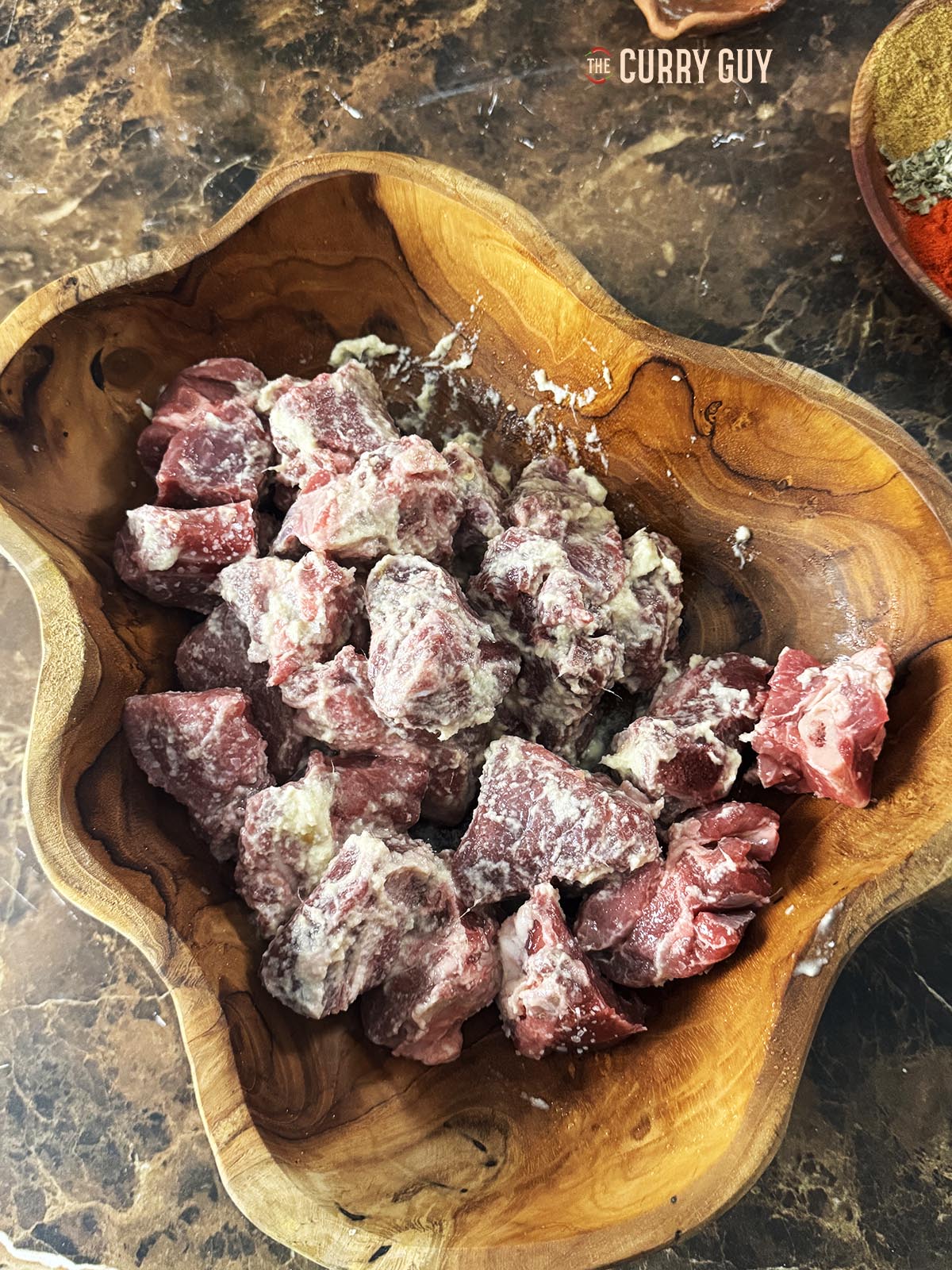 The lamb tikka marinating in garlic and ginger paste, salt and lime juice.