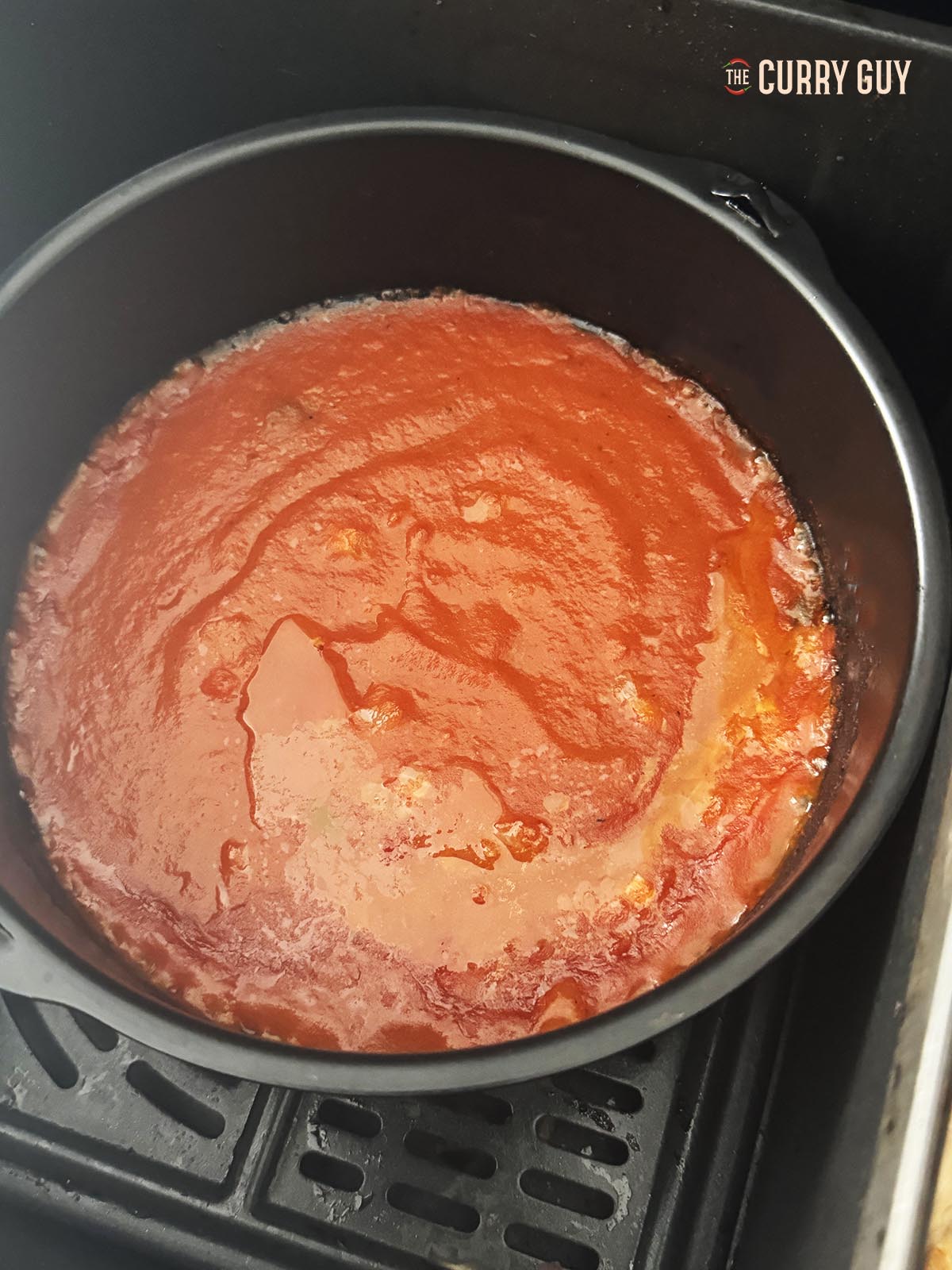 Pouring in the prepared curry sauce.