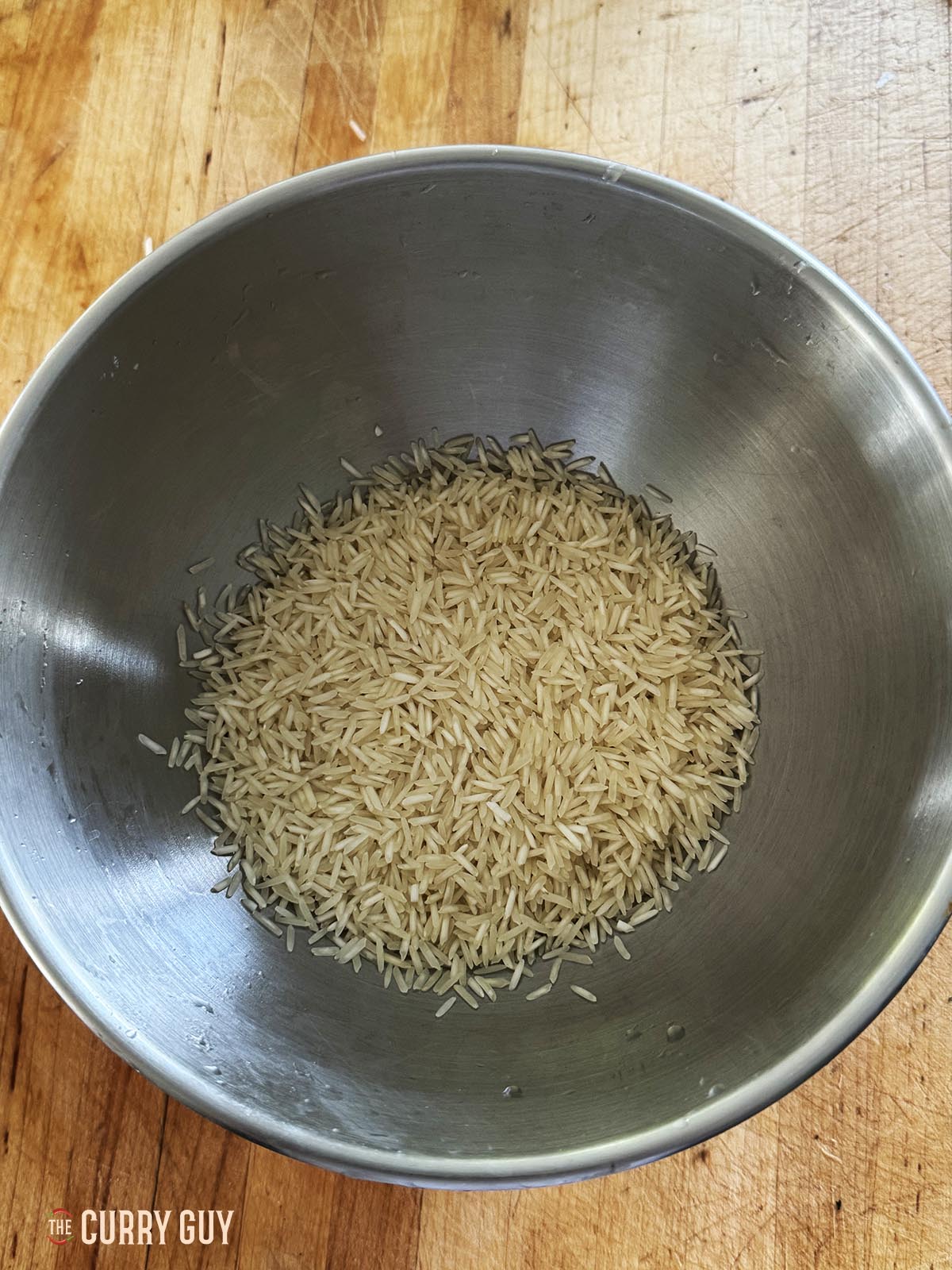 The rice measured out in a mixing bowl.