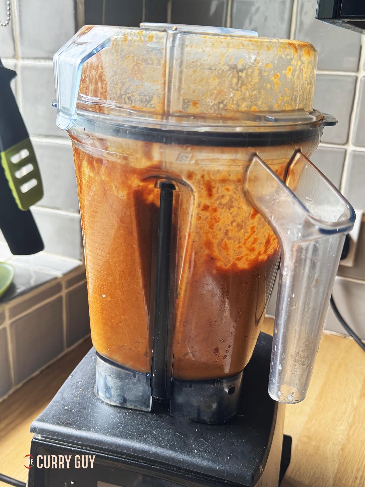 Blending the curry sauce ingredients in a blender.