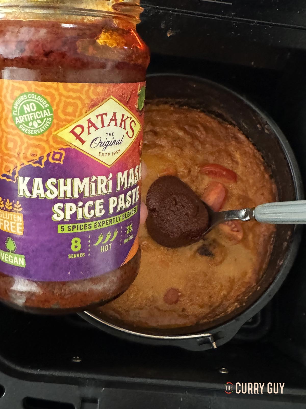 Adding Kashmiri paste to the curry sauce.