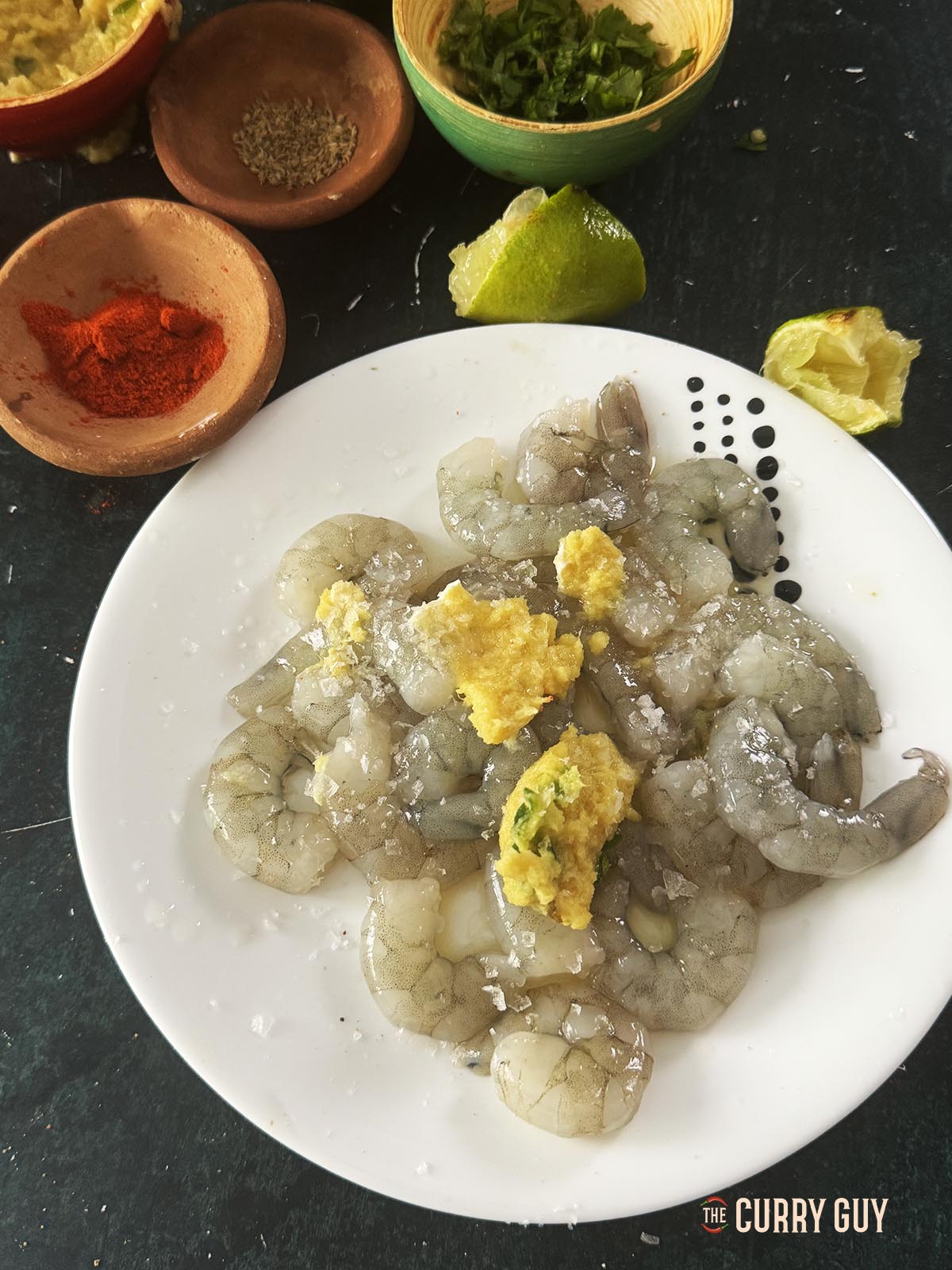 Rubbing the first marinade into the shrimp.