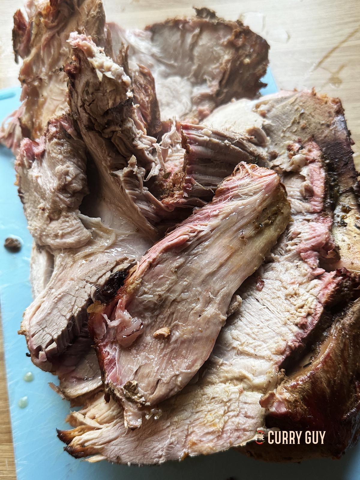 Tearing the meat apart into large chunks.