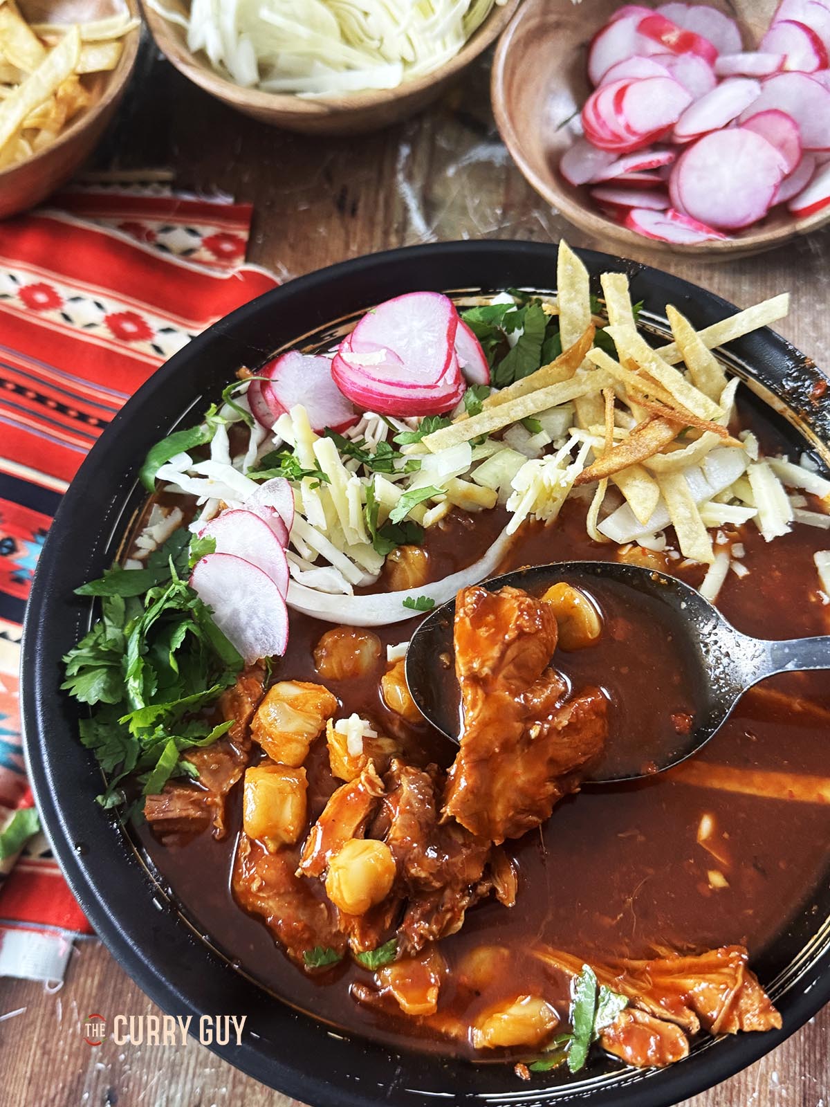 Pizole rojo topped with a selection of popular garnishes.