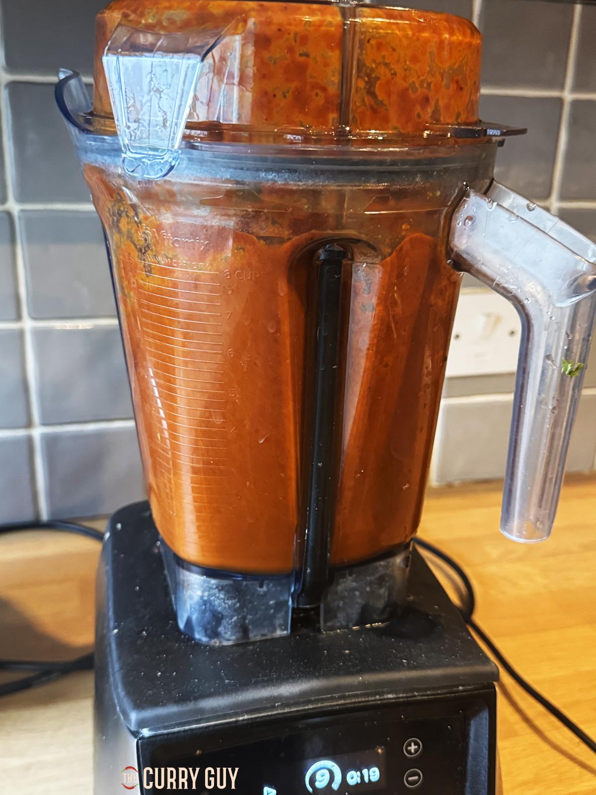 Blending the chilies, onion and garlic to a fine paste with the broth.