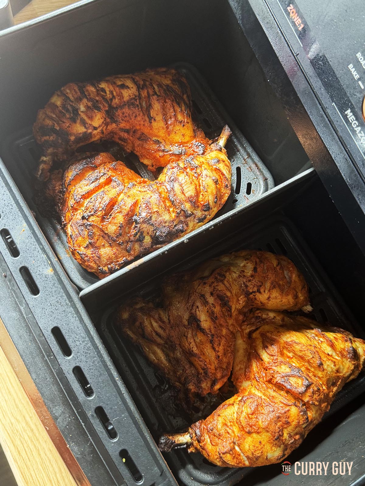 Cooking the chicken in the air fryer basket.