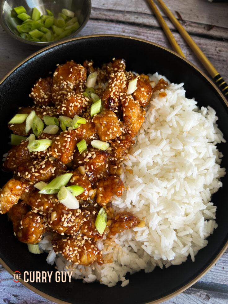 Air fryer sesame chicken served with rice.