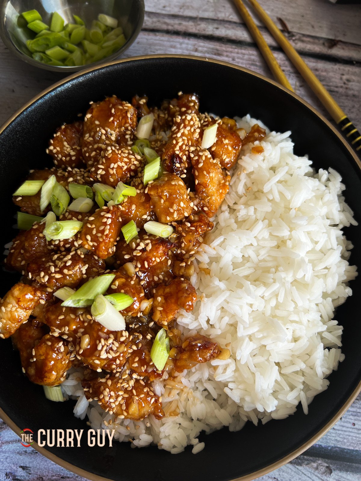 Air fryer sesame chicken served with rice.