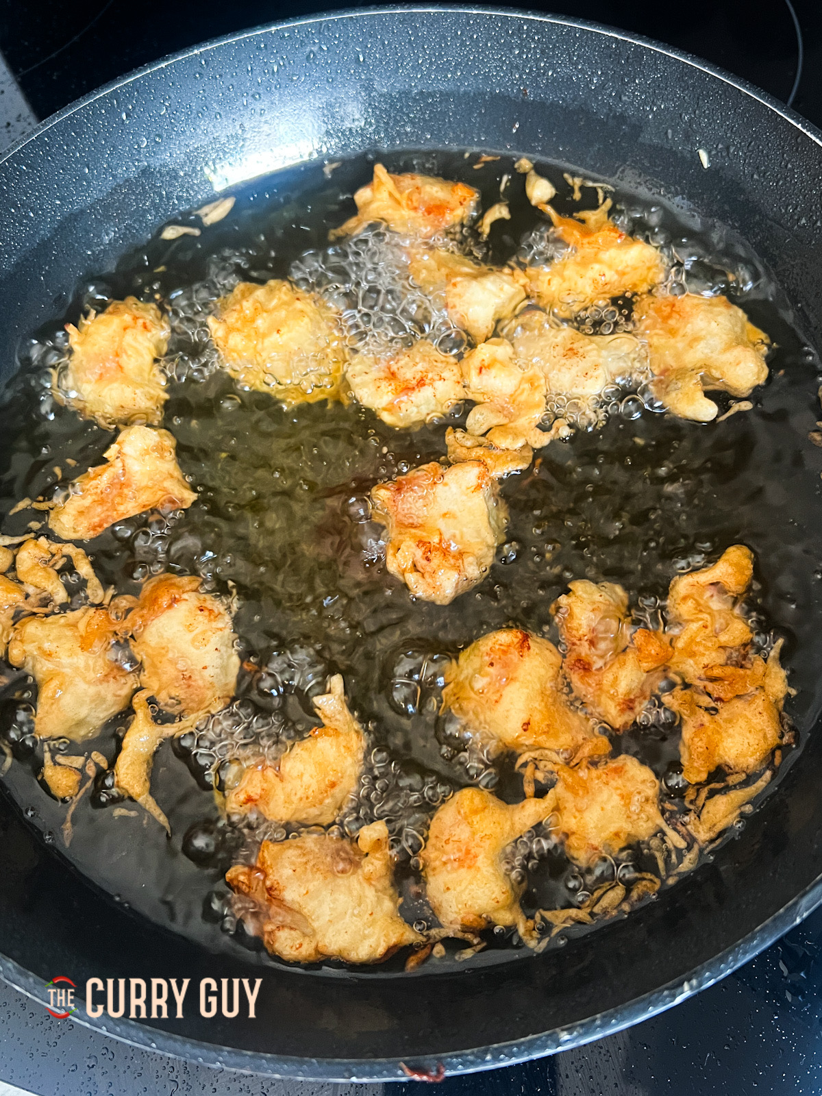 chicken frying in a pan.