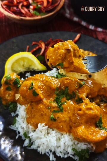 Air fryer chicken tikka masala on a plate and on a fork.
