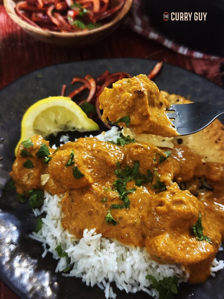 Air fryer chicken tikka masala on a plate and on a fork.