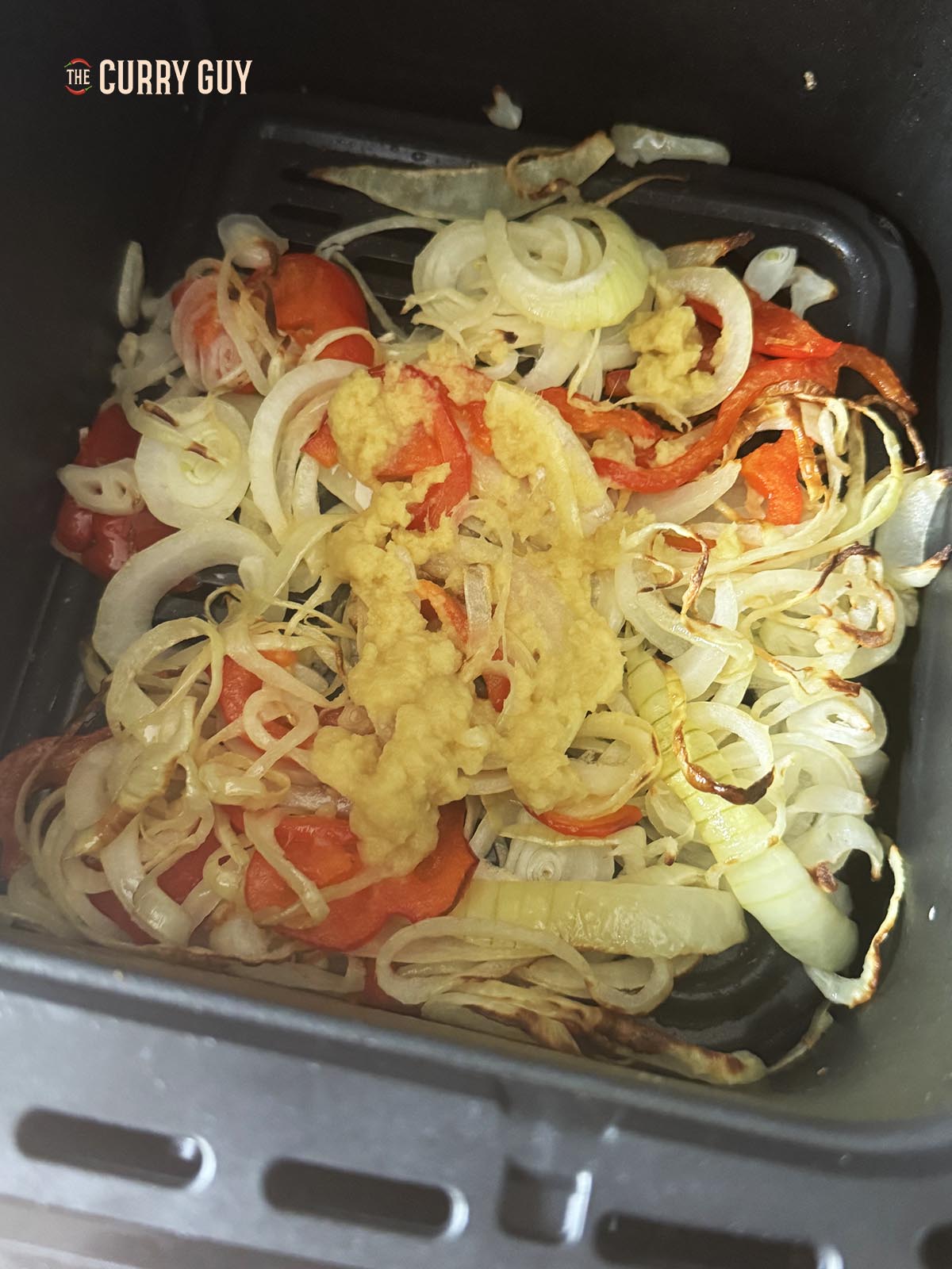 Frying the onions, bell pepper and garlic and ginger paste.