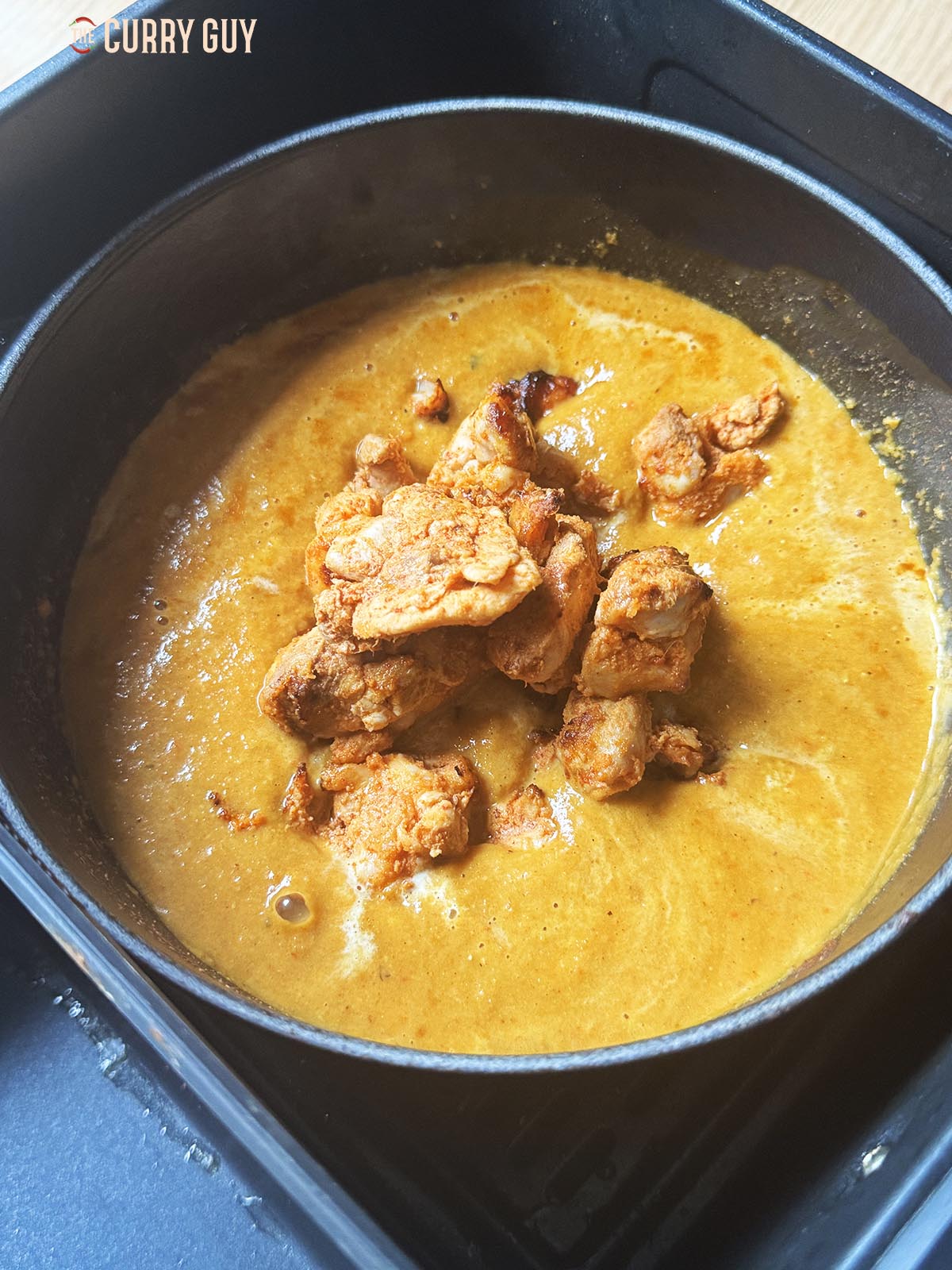 Adding the precooked chicken to the sauce.