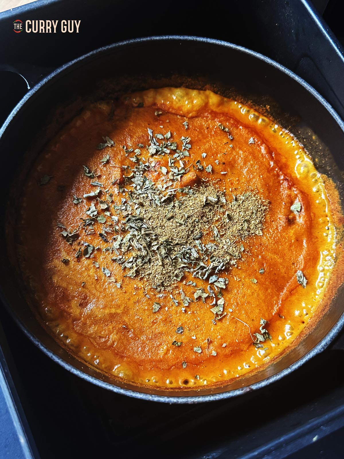 Adding kasoori methi and garam masala to the curry.