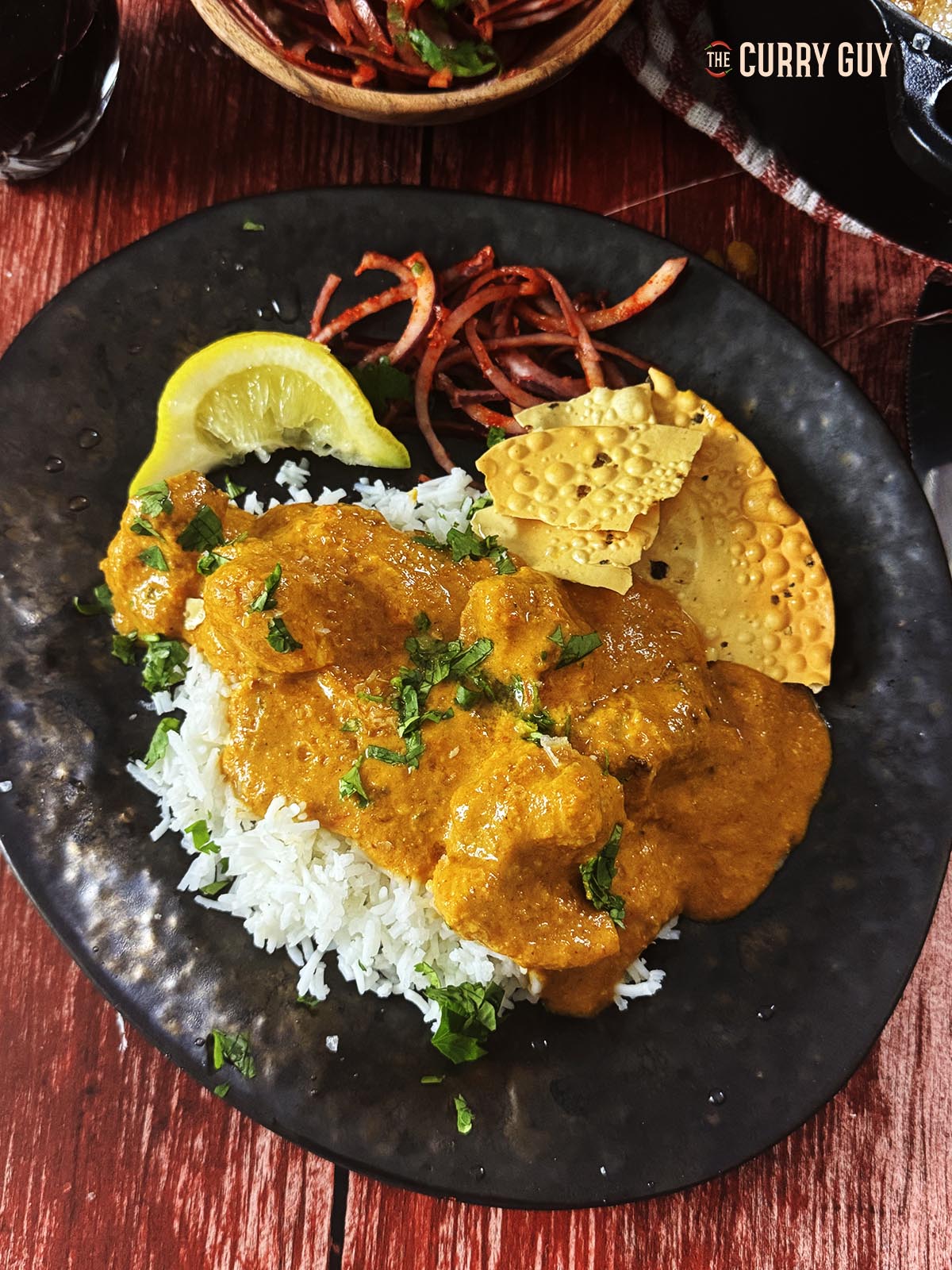Air fryer chicken tikka masala on a plate with rice.