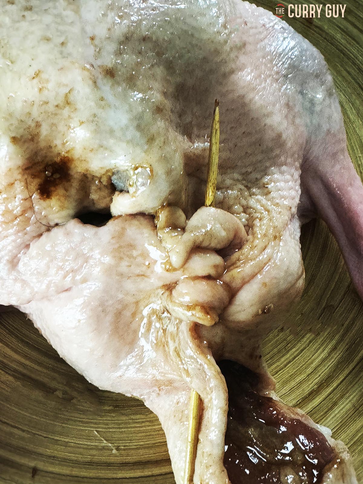 Closing the end of the duck with a wooden skewer.