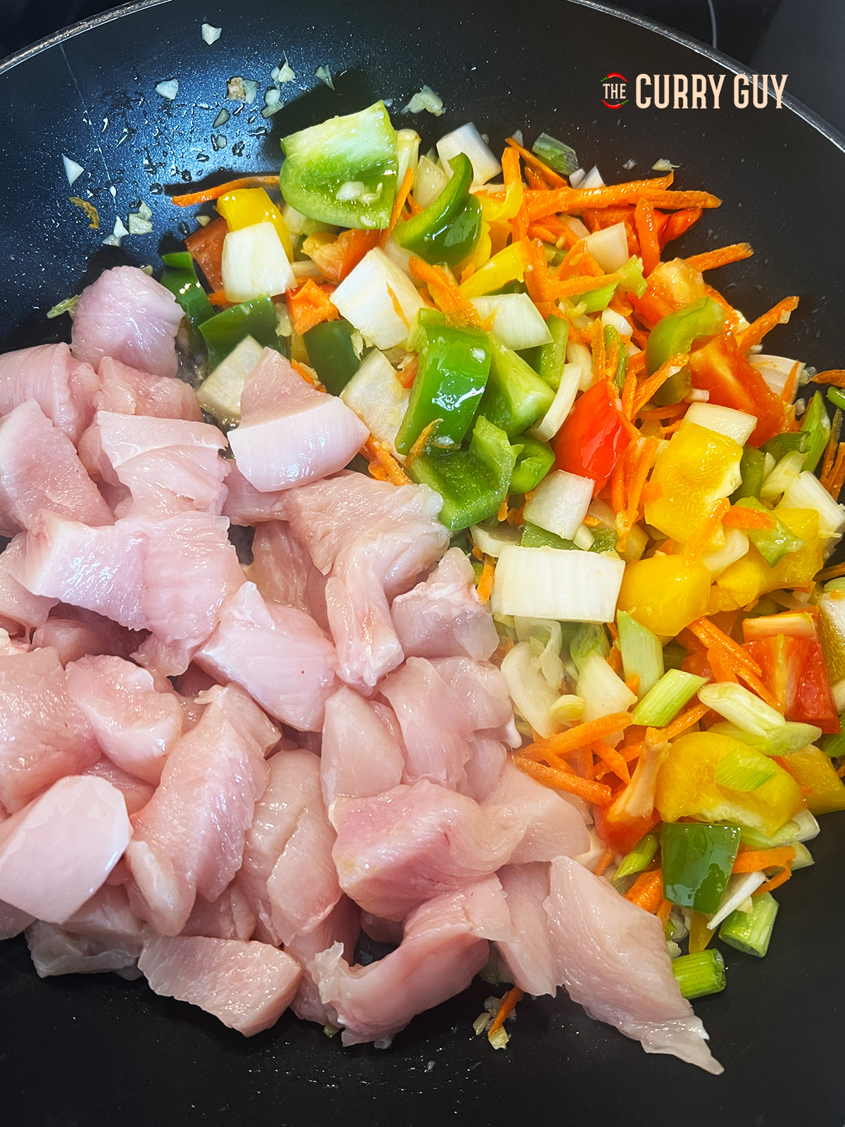 chicken and vegetables added to the pan 
