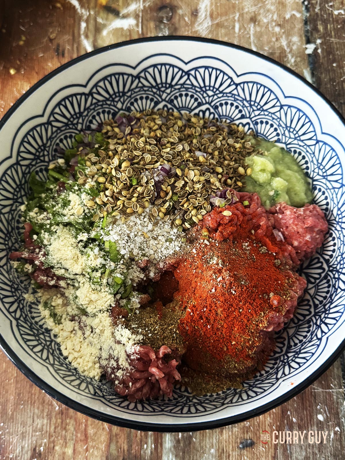 The kofta meatball ingredients in a mixing bowl.