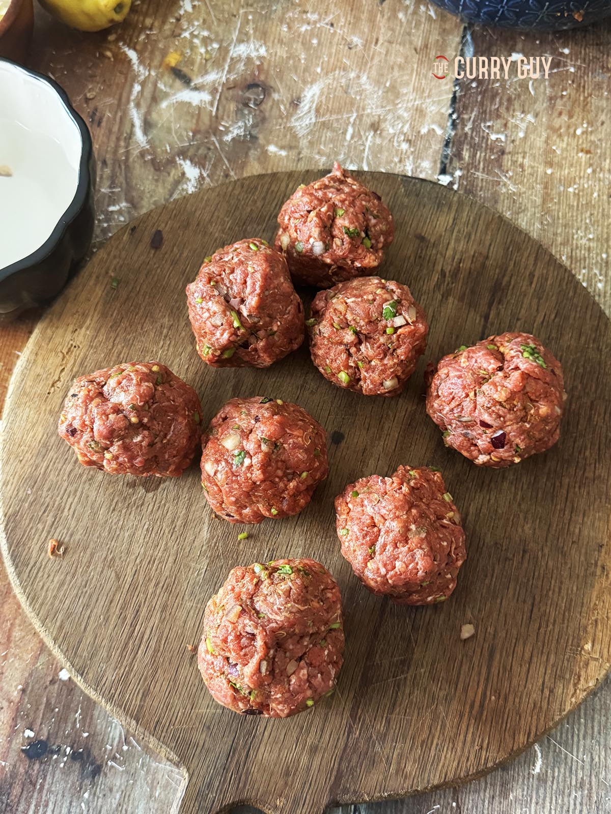 The meat mixture divided into eight equal sized balls. 