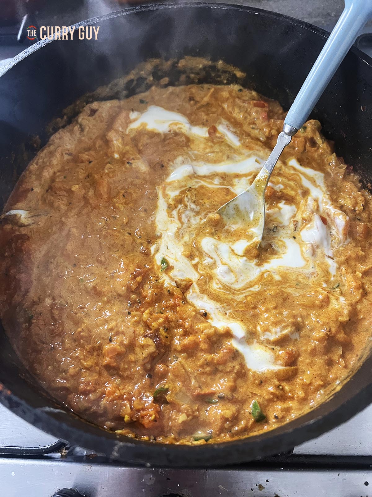 Adding the yoghurt to the sauce.