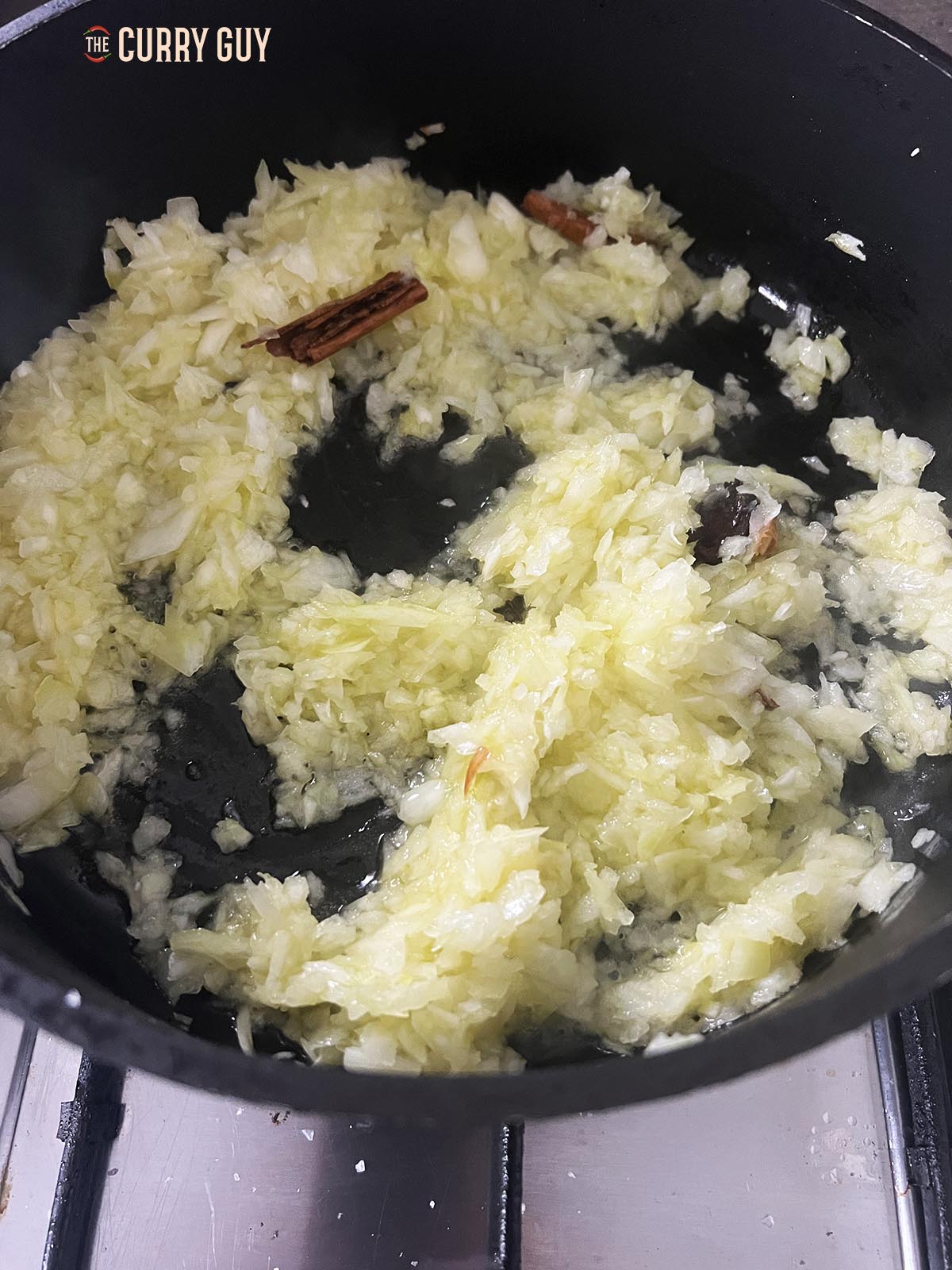 Frying the onions in a large pan until soft and translucent.