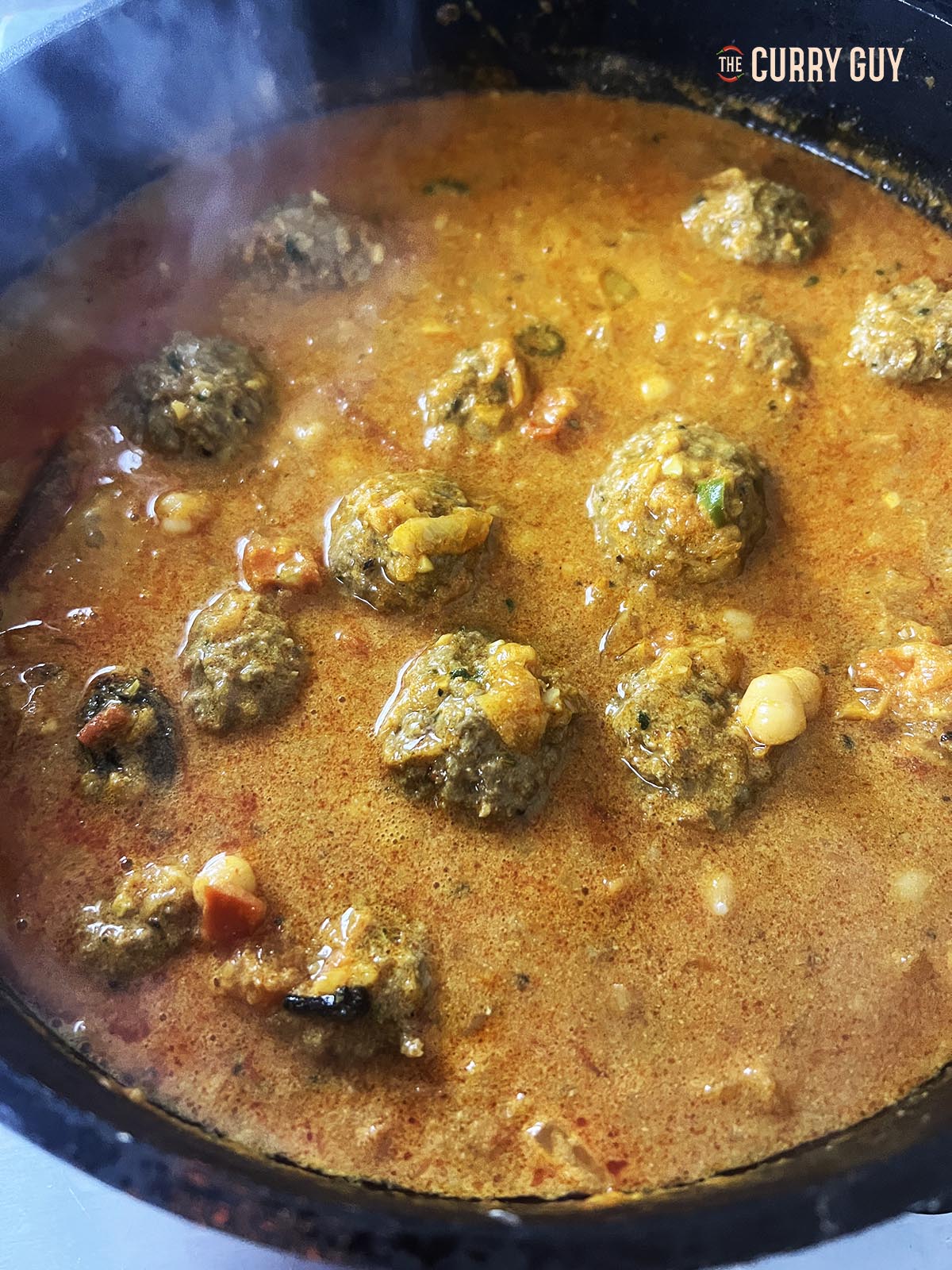 Adding the chickpeas to the sauce. 