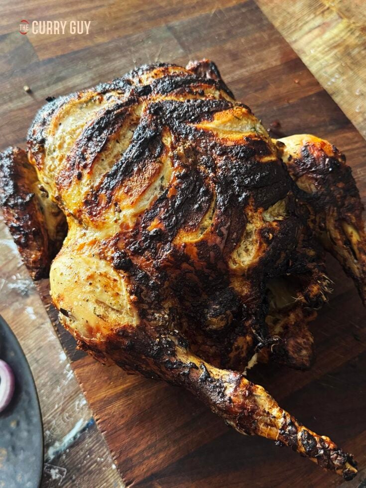 South Indian Tandoori Chicken on a cutting board.