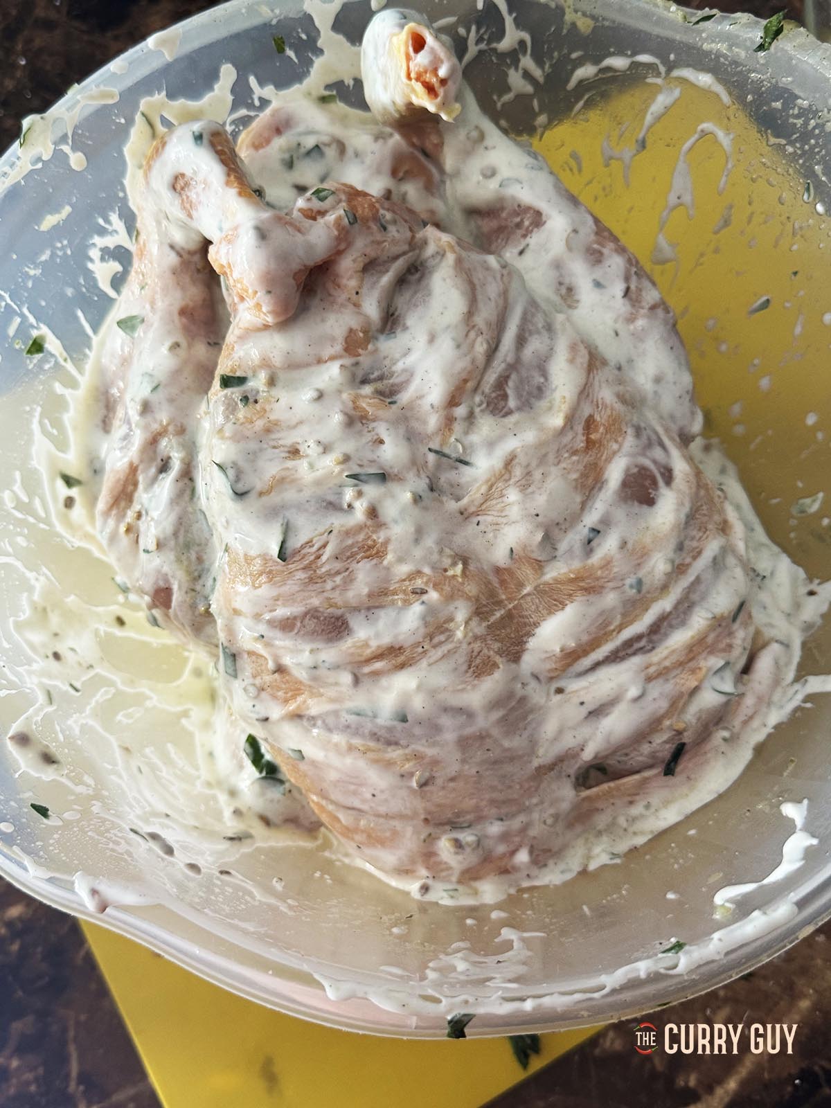 The chicken coated with the marinade.