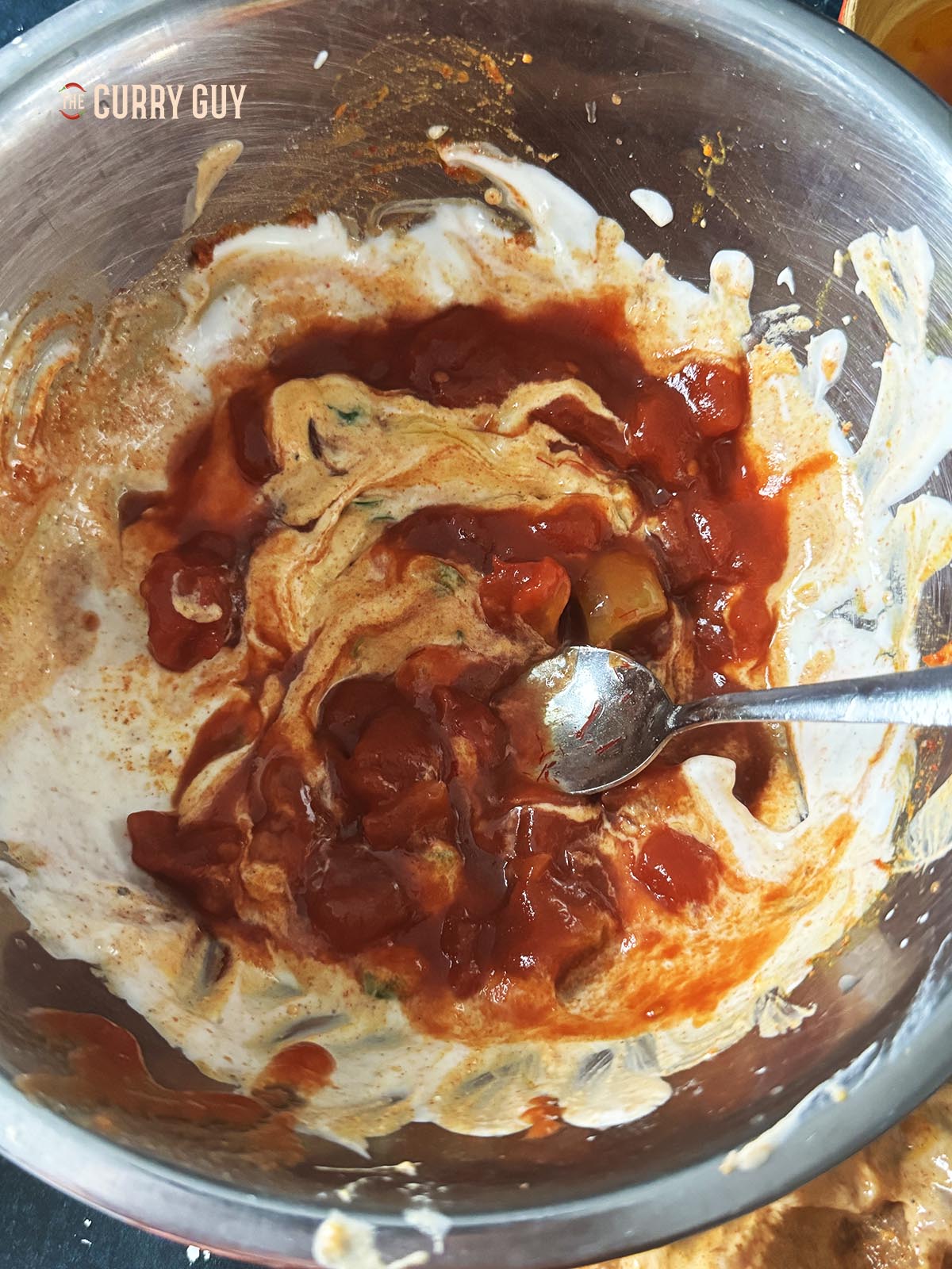 Adding the chopped tomatoes to the remaining marinade. 