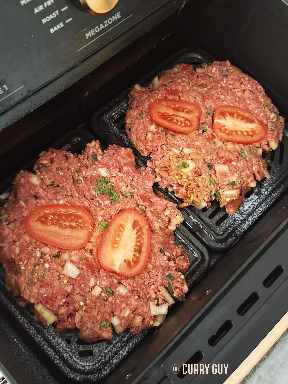 The chapli patties in an air fryer ready to start cooking. 