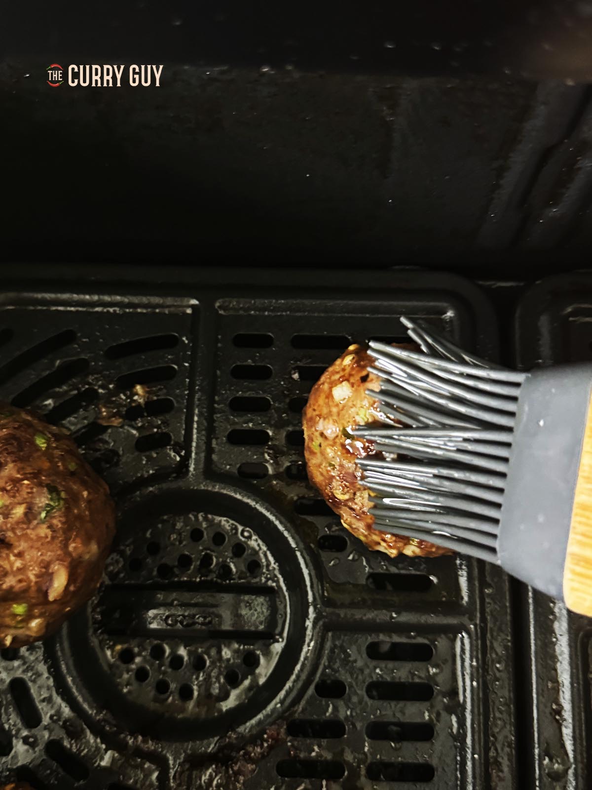 Basting a cooked kofta.