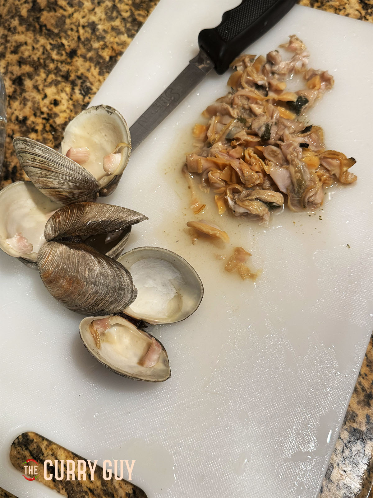 Removing the cooked clams from the shells