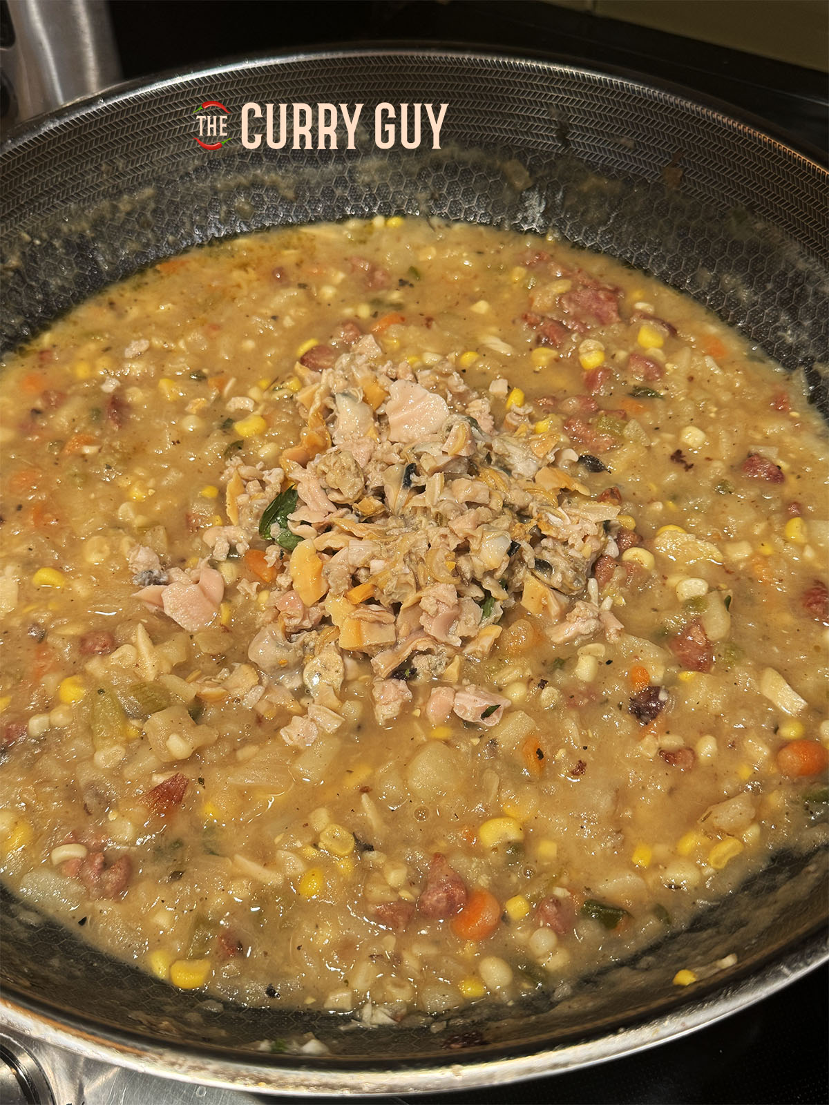 The cooked clams added to the vegetables and stock