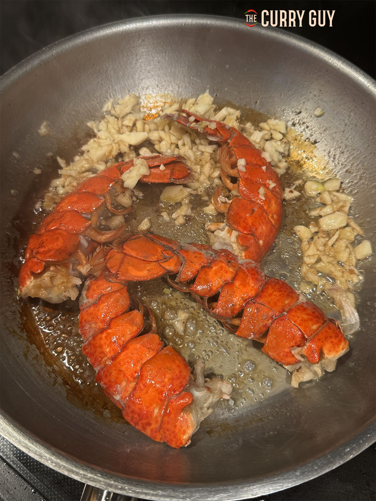 Lobster tails frying with garlic