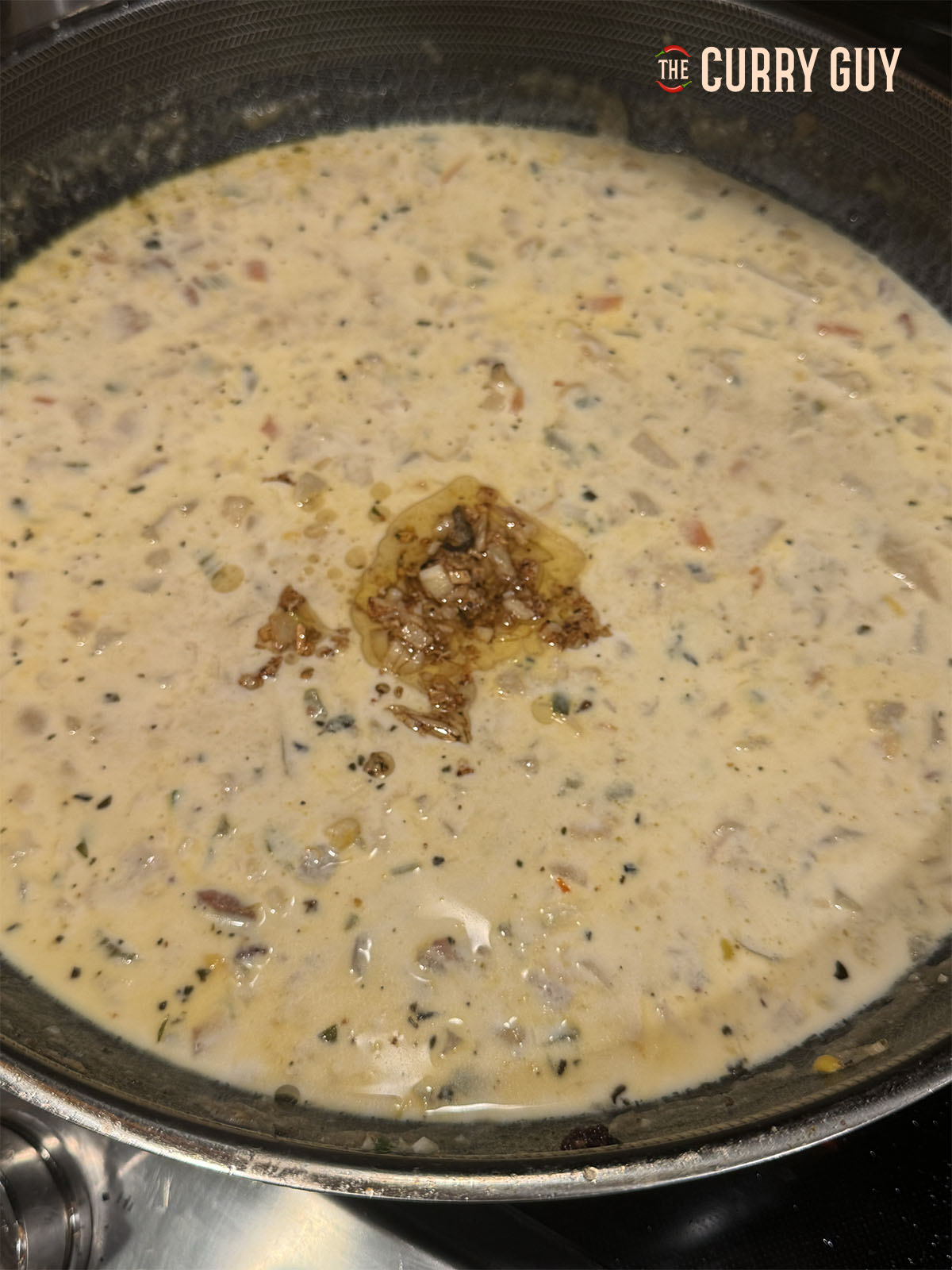 The chowder ready to serve with some slowly cooked garlic on top to stir in.