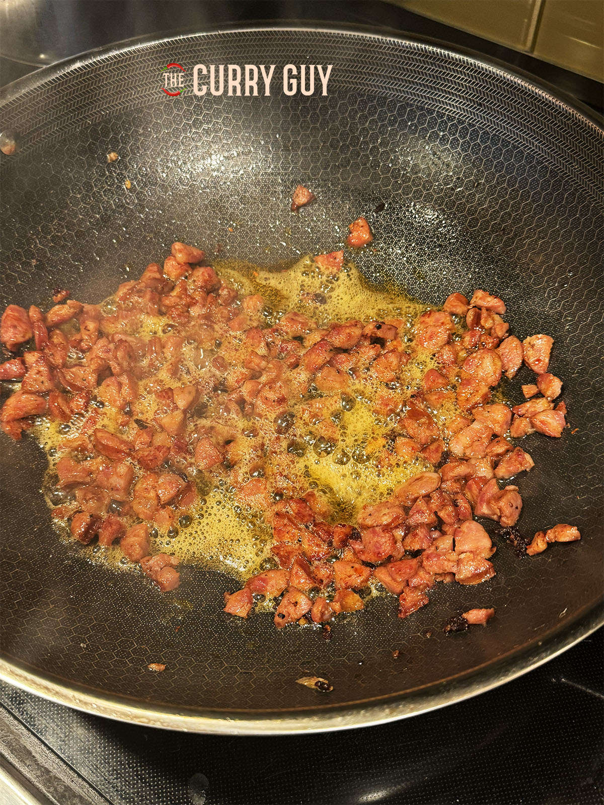 The pancetta gently frying