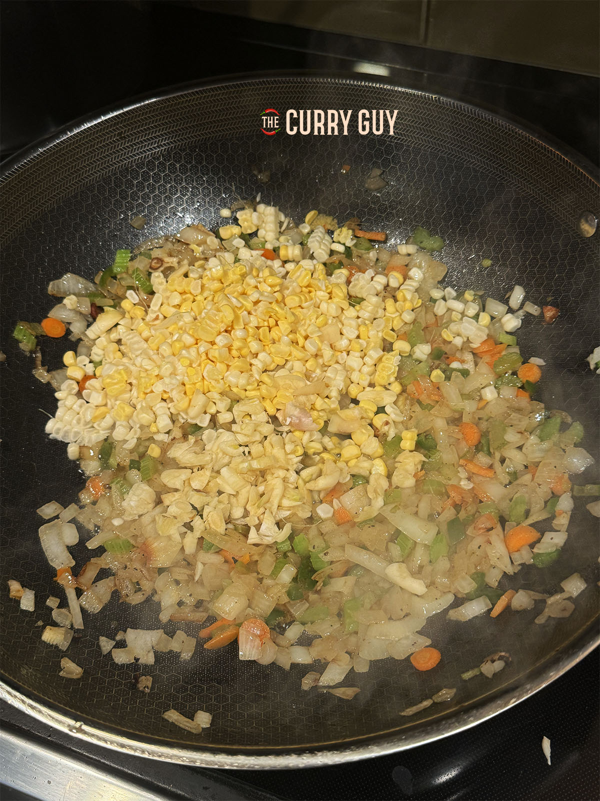 The sweet corn added to the frying pan