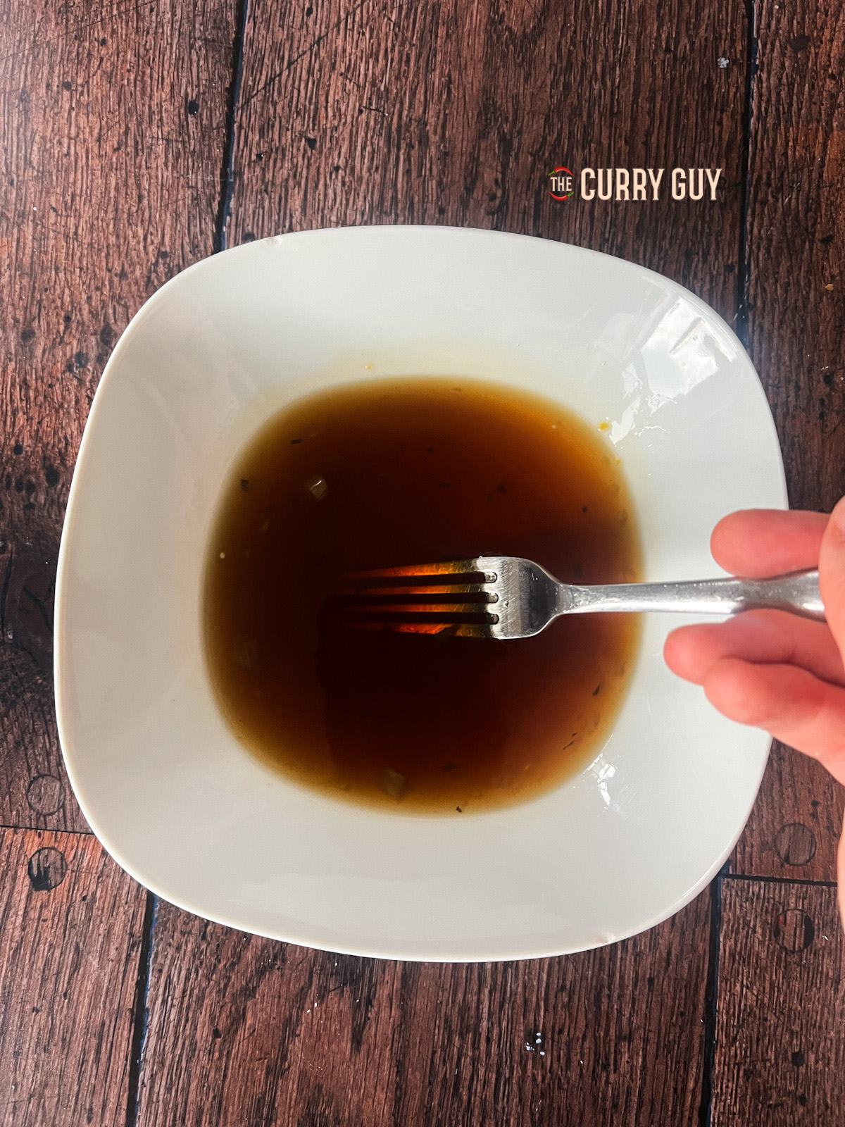 Whisking sauce ingredients together