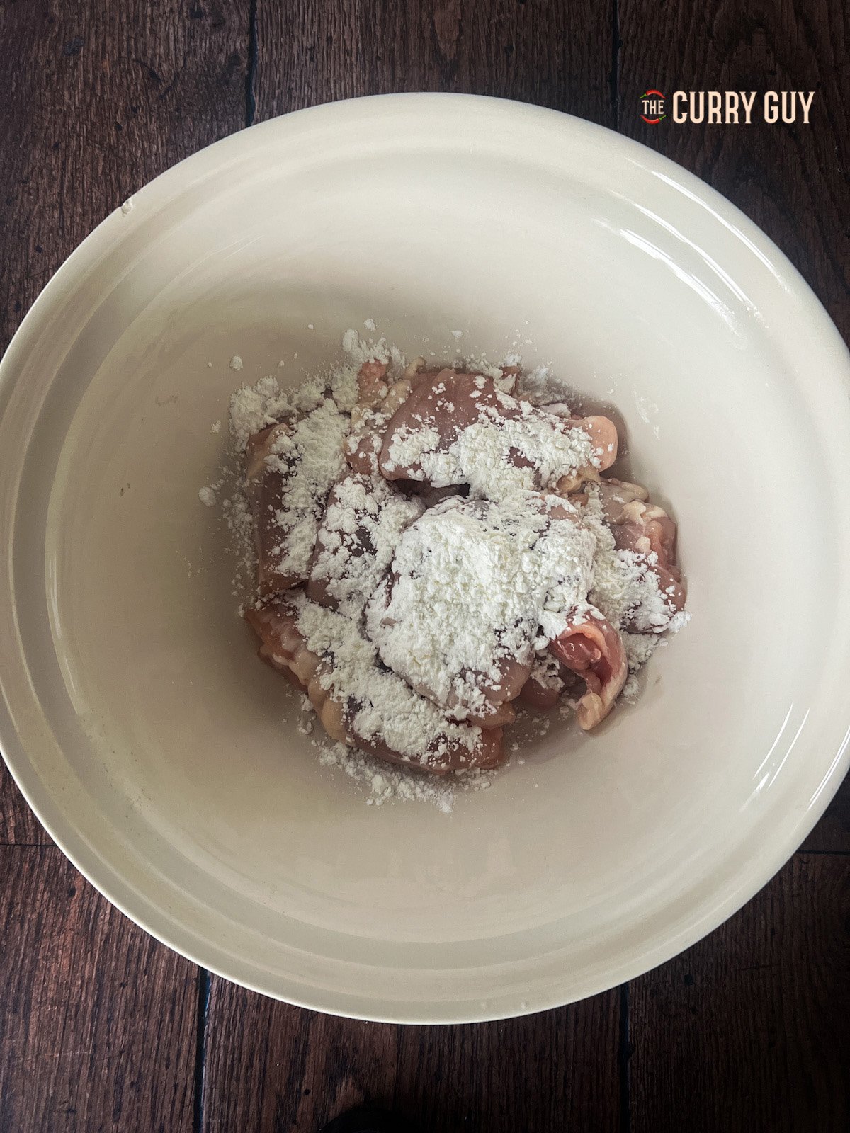 chicken in a bowl coated in cornflour