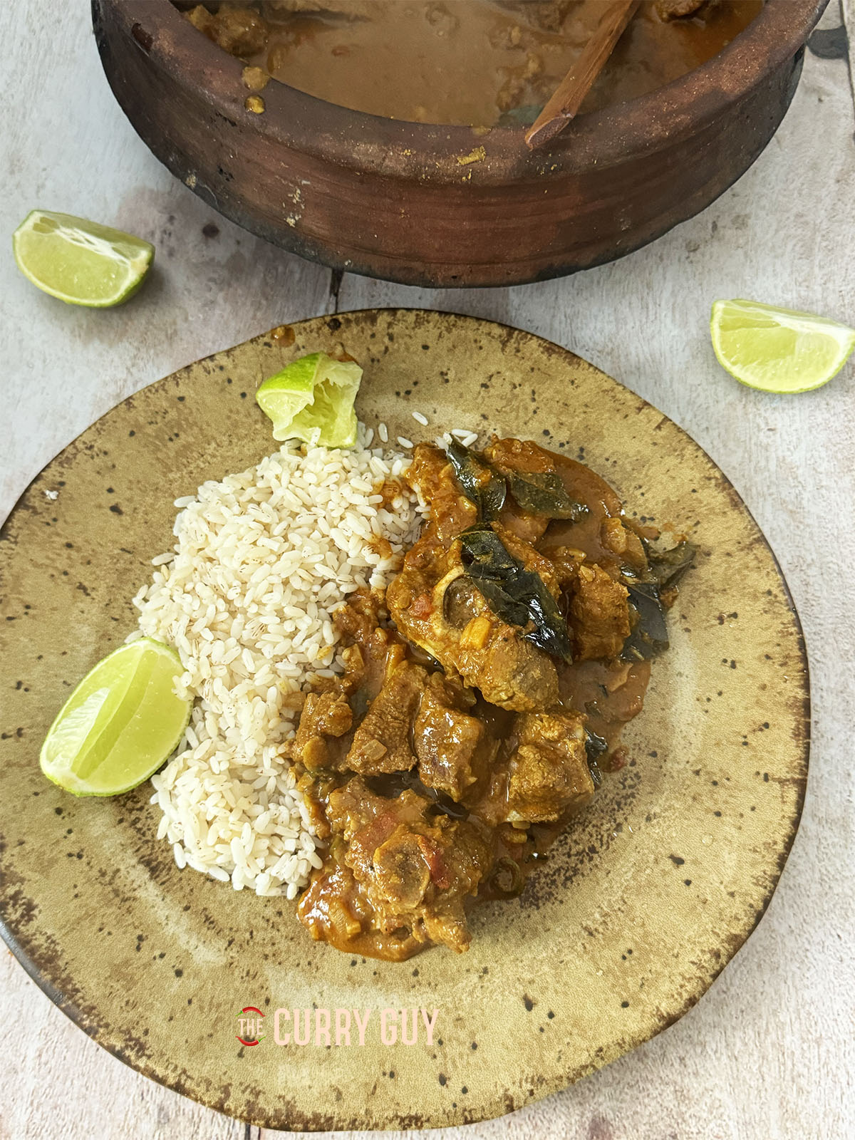 Keralan lamb curry served on a plate at the table.