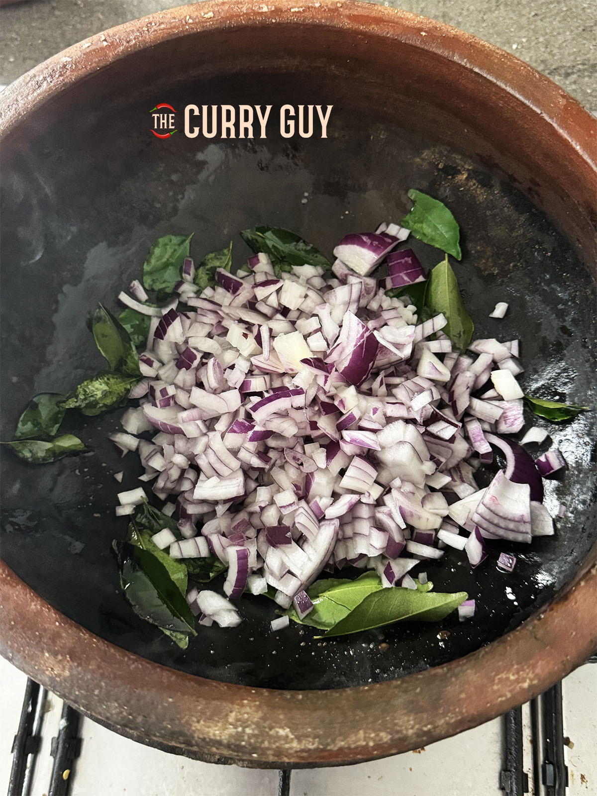 Adding and then frying onions in the pot.