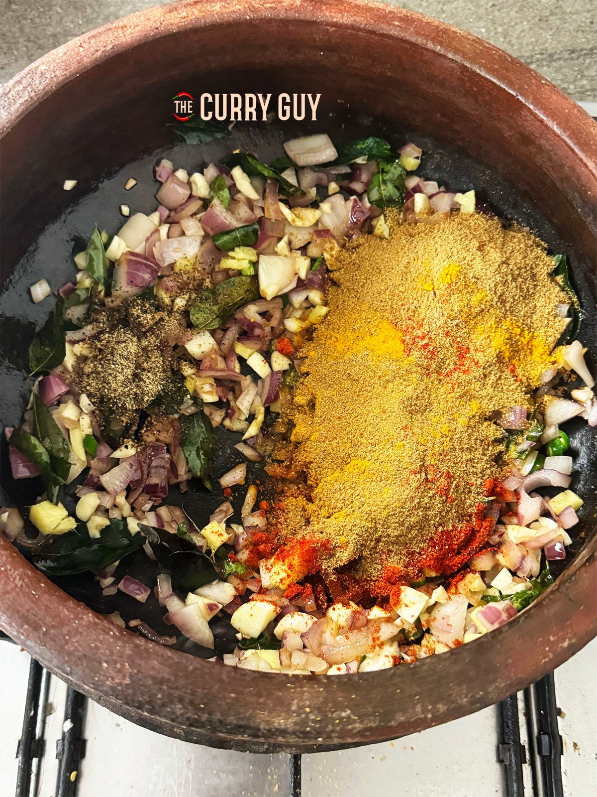 Stirring the ground spices into the onion mixture in the pot.