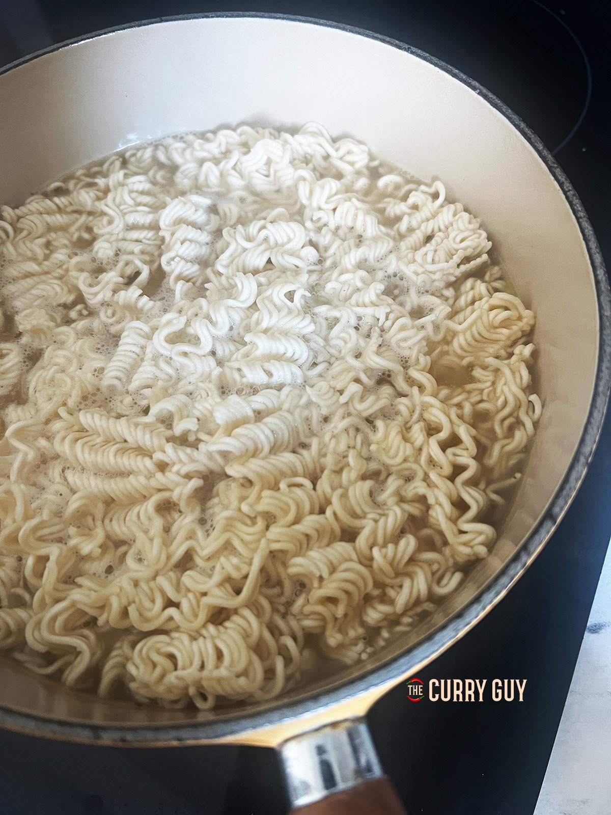 noodles simmering in a pan 