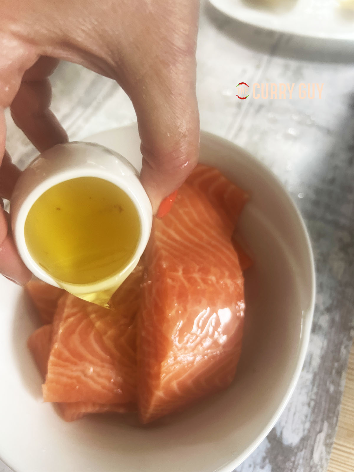 Covering each salmon steak with lime juice.