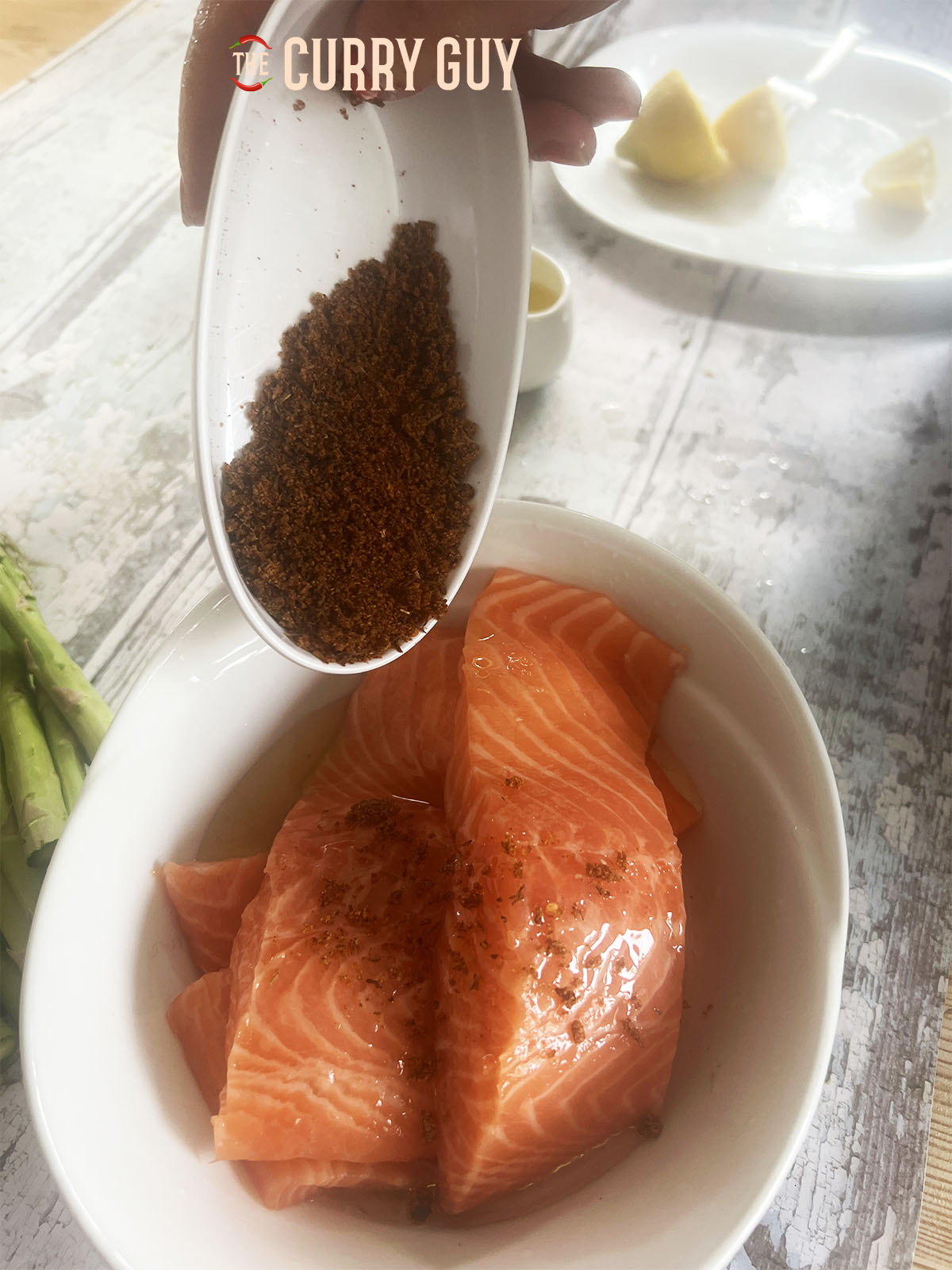 Tipping the Cajun spice over the salmon steaks.