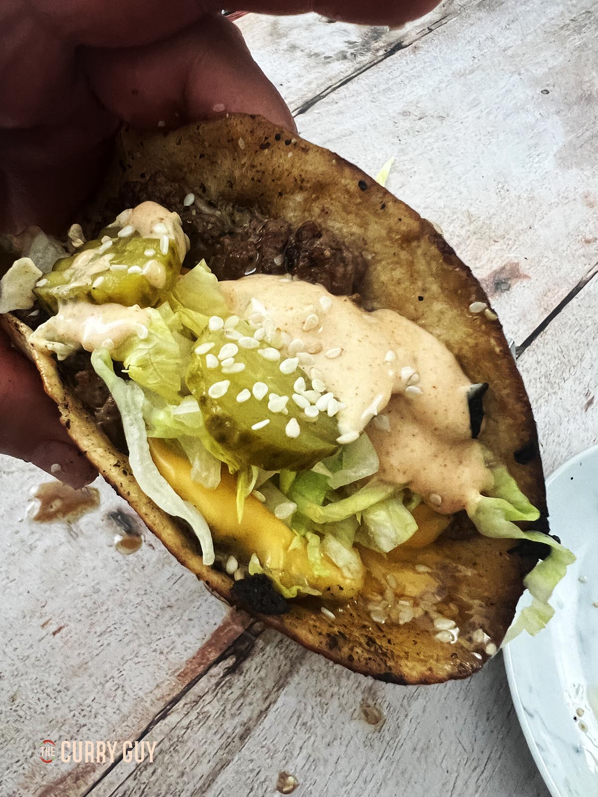 Holding a Big Mac Taco.