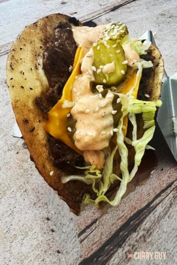 Big Mac Taco in a taco holder at the table.