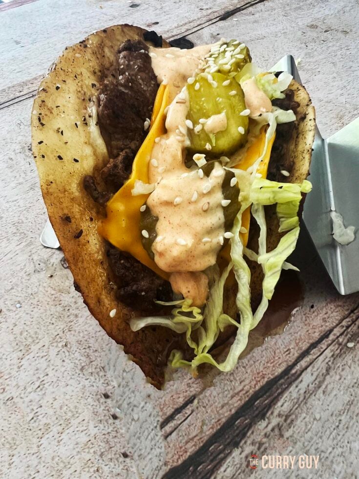 Big Mac Taco in a taco holder at the table.