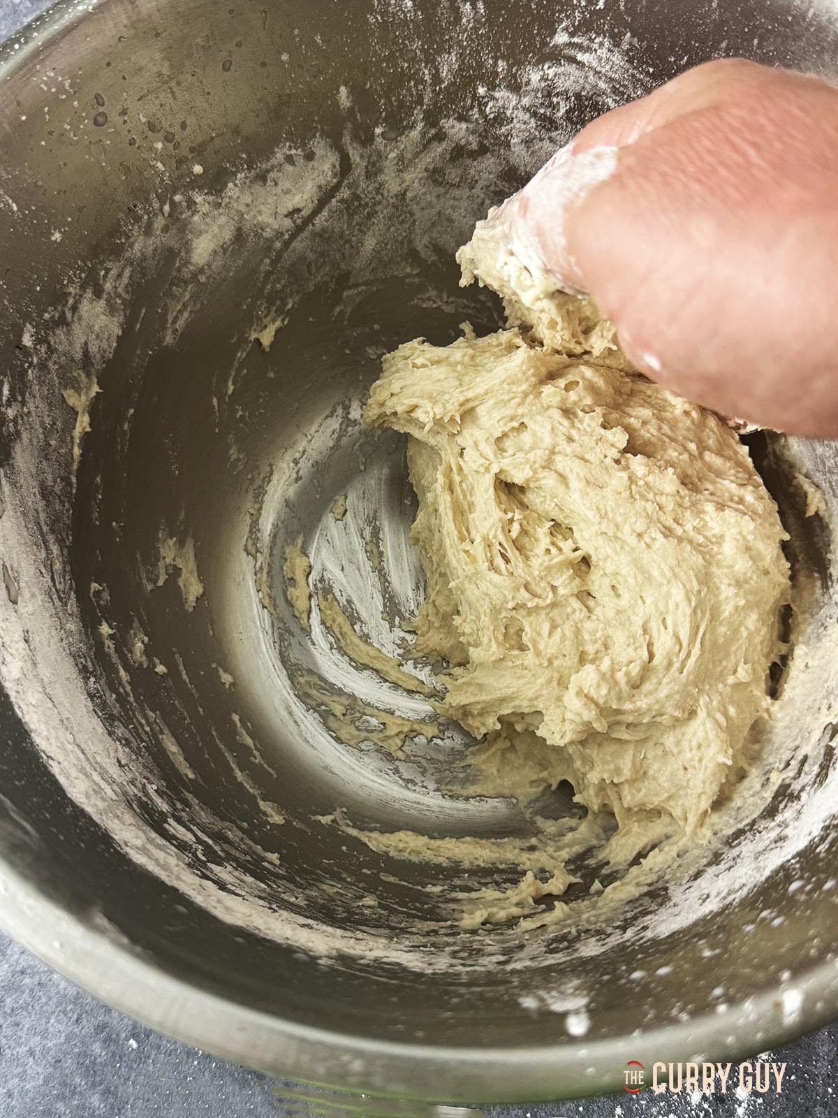 Beginning to knead the dough. It is still quite wet and sticky at this stage.
